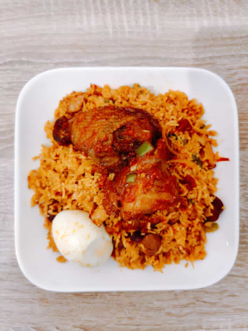 Jollof rice with chicken and boiled egg